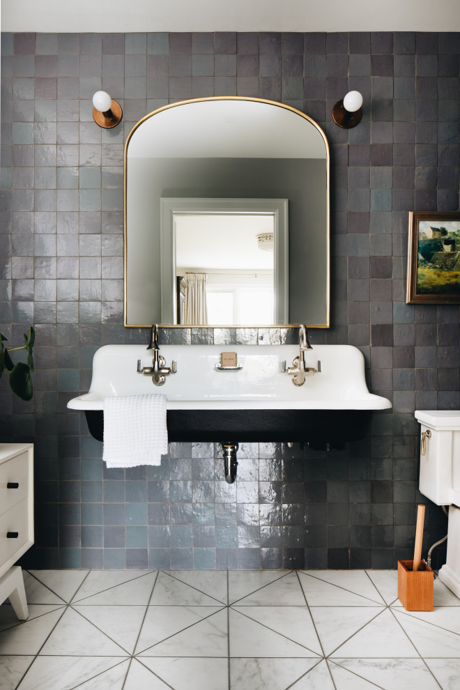 Design ideas for a transitional bathroom in Grand Rapids with black cabinets, a freestanding tub, multi-coloured tile, mosaic tile, multi-coloured walls, marble floors, a wall-mount sink, white floor, white benchtops, a double vanity and a floating vanity.