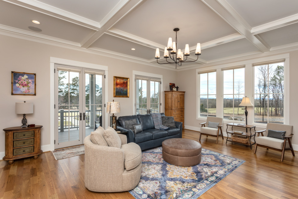 This is an example of a large mediterranean open concept family room in Other with beige walls, medium hardwood floors and coffered.