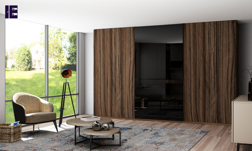 Design ideas for a mid-sized contemporary built-in wardrobe in London with glass-front cabinets and dark wood cabinets.