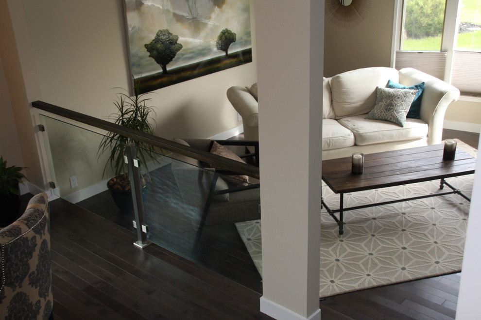 Photo of a large contemporary living room in Calgary with beige walls and dark hardwood floors.