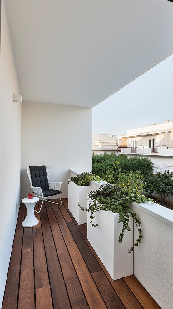 Photo of a small contemporary balcony in Bari with a roof extension.