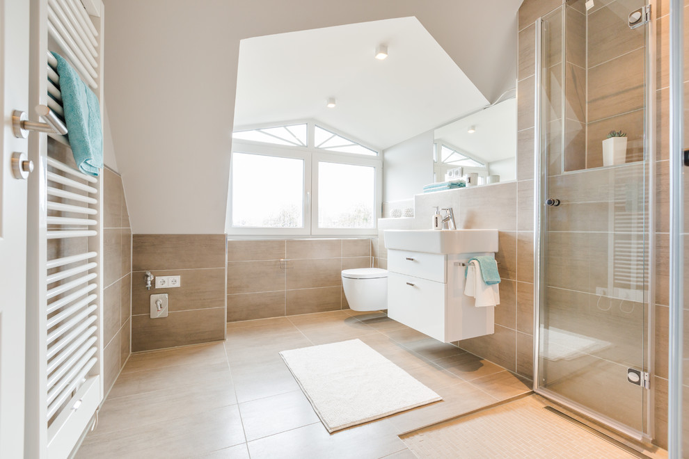 This is an example of a mid-sized contemporary master bathroom in Other with flat-panel cabinets, white cabinets, a curbless shower, a wall-mount toilet, beige tile, cement tile, white walls, porcelain floors and a pedestal sink.