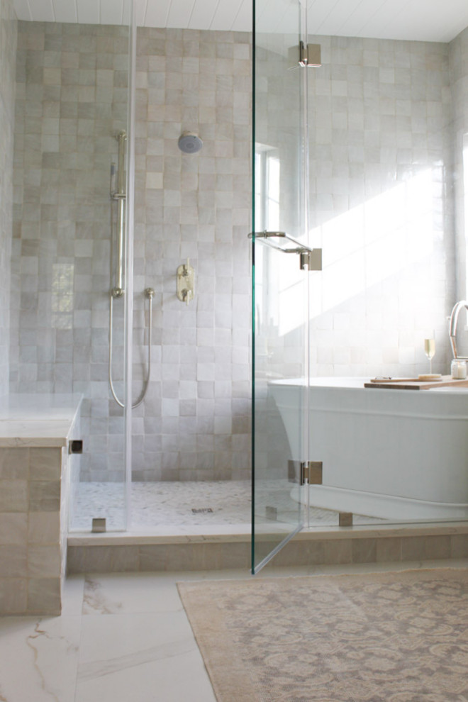 Design ideas for a transitional master wet room bathroom in Orlando with shaker cabinets, medium wood cabinets, a freestanding tub, ceramic tile, white walls, porcelain floors, a hinged shower door, a niche, a double vanity, a freestanding vanity and timber.