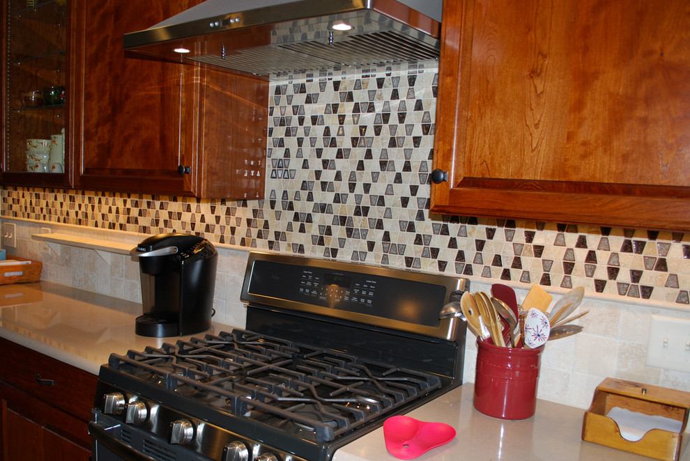 Example of a kitchen design in DC Metro with multicolored backsplash and travertine backsplash