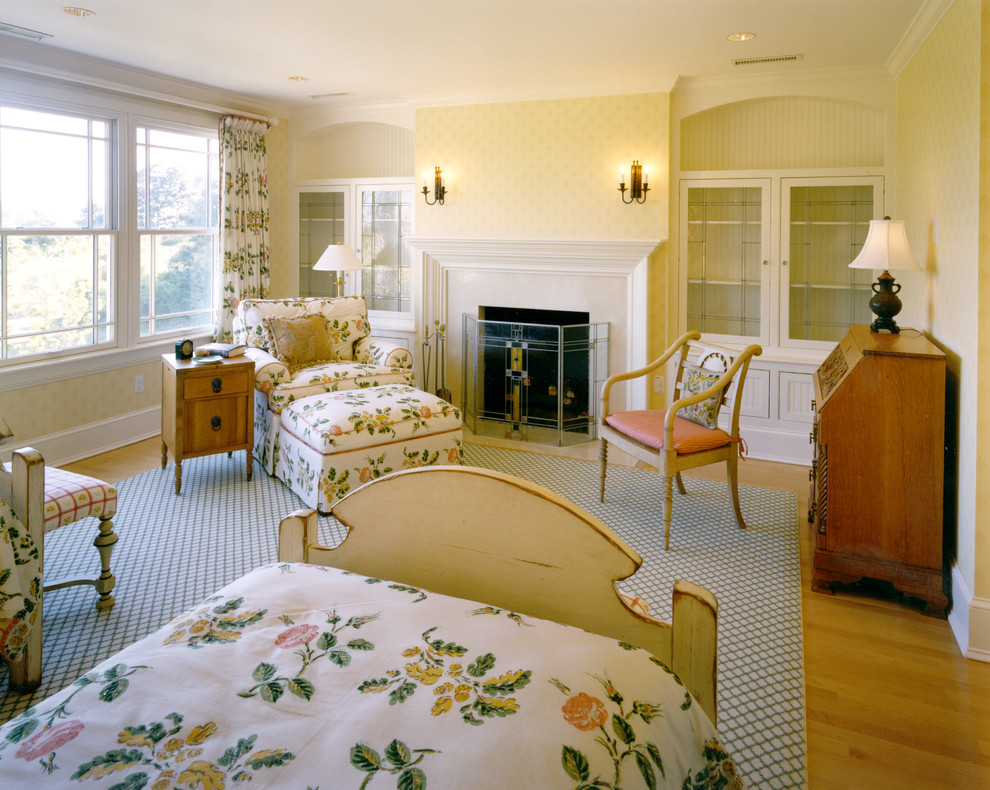 This is an example of a traditional bedroom in Boston with a standard fireplace.