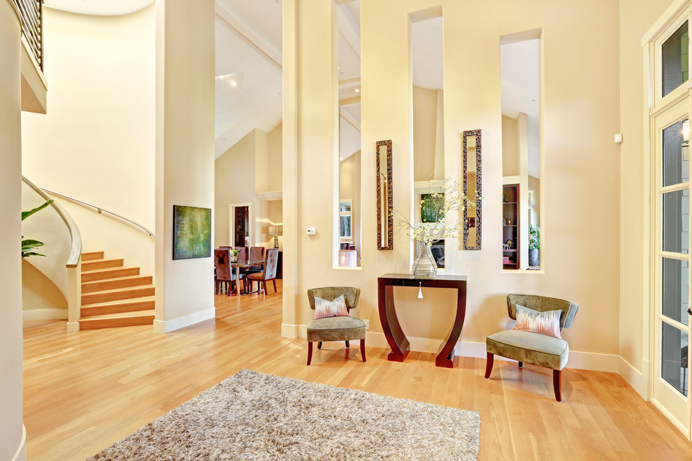 Design ideas for a large traditional foyer in San Francisco with beige walls, light hardwood floors and a glass front door.