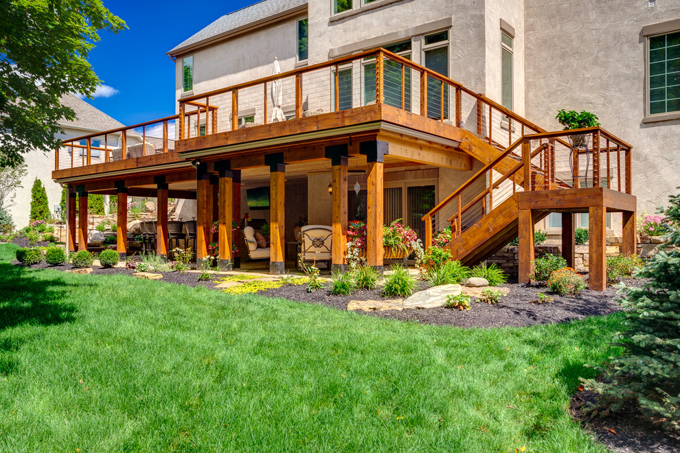 Example of a mid-sized mountain style courtyard stone deck design in Columbus
