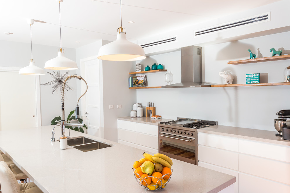 Design ideas for a large contemporary galley kitchen in Sydney with white cabinets, stainless steel appliances, with island, a double-bowl sink and flat-panel cabinets.