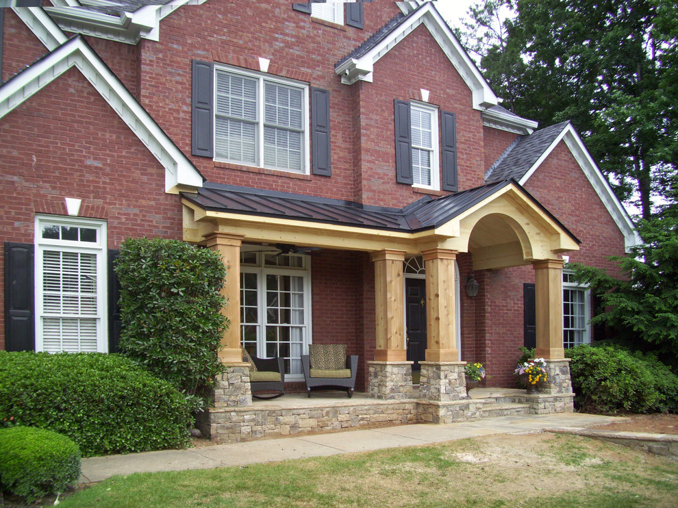 Inspiration for a transitional front yard verandah in Atlanta with a roof extension.