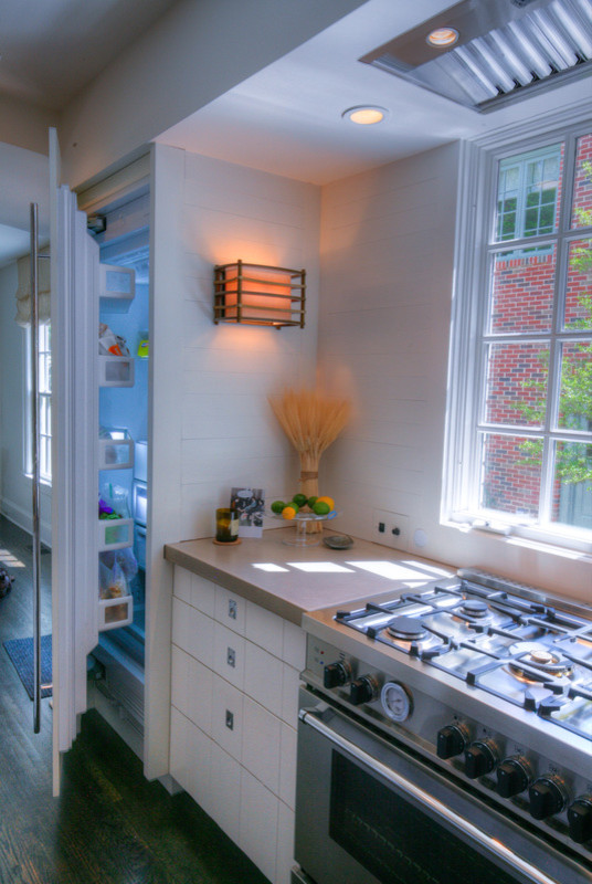 Eat-in kitchen - mid-sized contemporary u-shaped dark wood floor eat-in kitchen idea in Charlotte with an undermount sink, flat-panel cabinets, white cabinets, white backsplash, ceramic backsplash, stainless steel appliances and an island