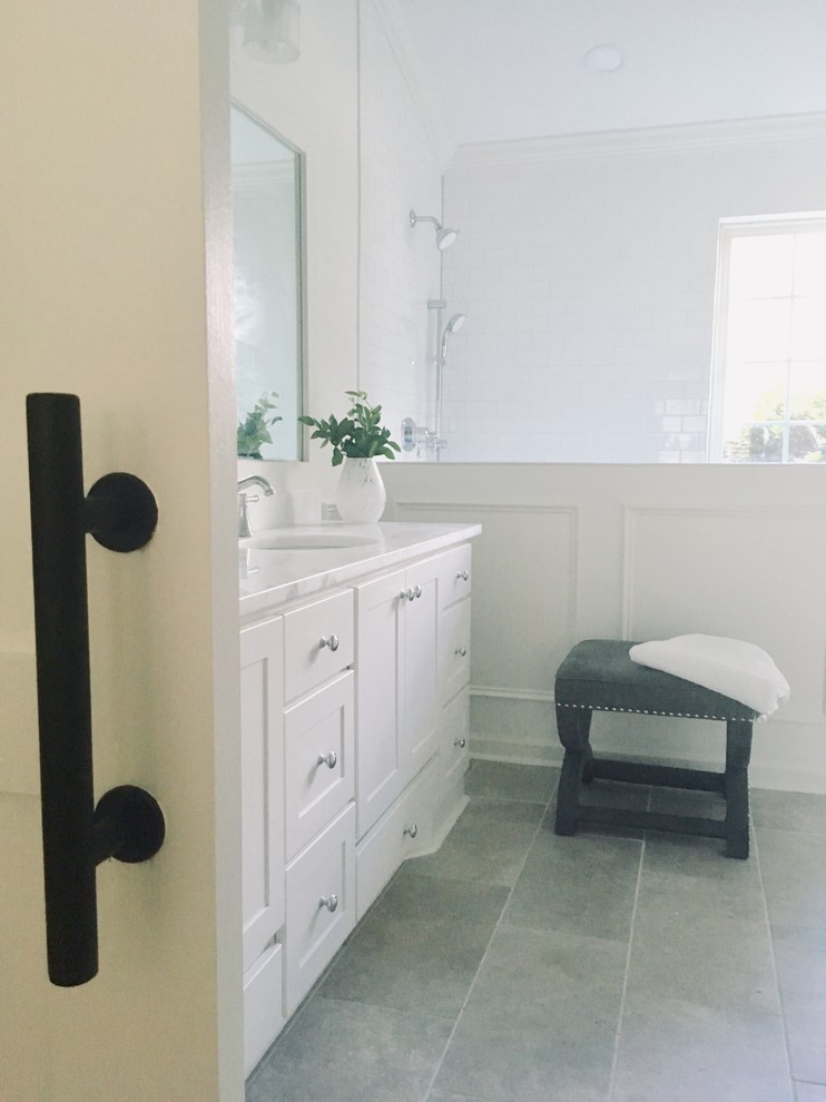 This is an example of a mid-sized traditional master bathroom in Charleston with shaker cabinets, white cabinets, an open shower, a one-piece toilet, white tile, ceramic tile, grey walls, porcelain floors, an undermount sink, quartzite benchtops, grey floor, an open shower and white benchtops.