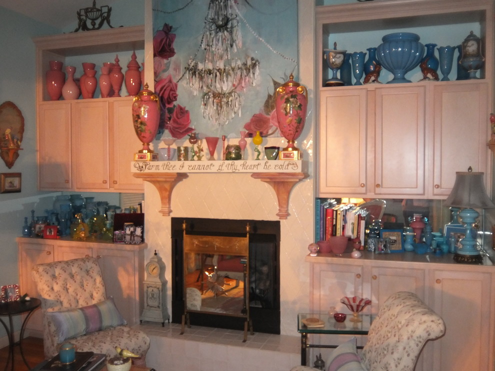 Inspiration for a small eclectic enclosed living room in Other with a library, blue walls, medium hardwood floors, a standard fireplace, a tile fireplace surround and no tv.