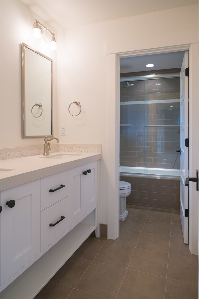 Inspiration for a mid-sized transitional kids' porcelain tile porcelain tile drop-in bathtub remodel with an undermount sink, shaker cabinets and white cabinets