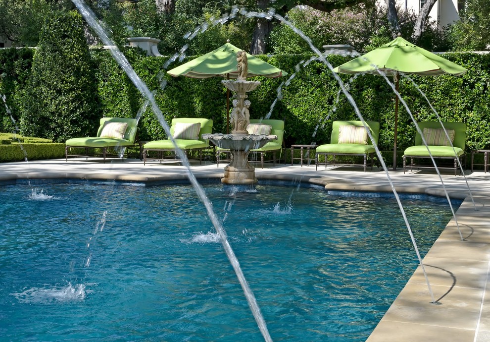 Traditional pool in Dallas with a water feature.