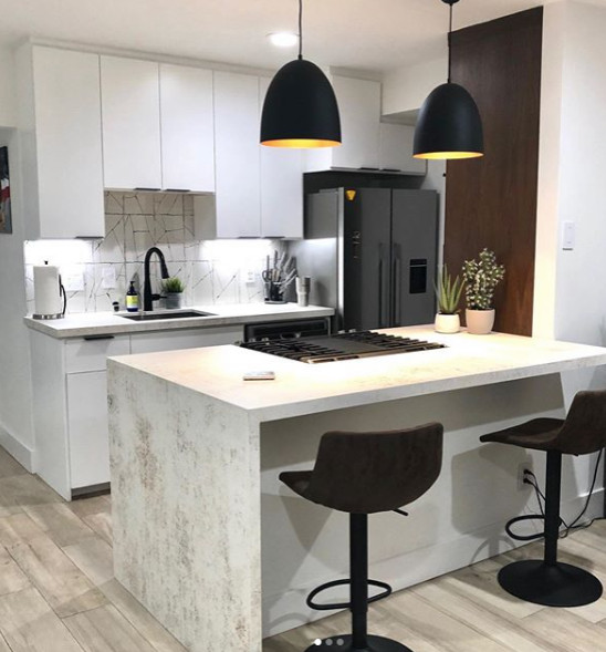 This is an example of a small modern galley eat-in kitchen in Austin with an undermount sink, flat-panel cabinets, white cabinets, white splashback, a peninsula, beige floor and multi-coloured benchtop.
