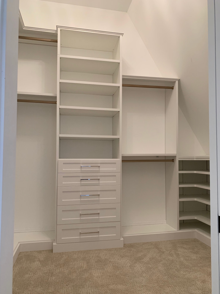 Photo of a mid-sized traditional walk-in wardrobe in Chicago with shaker cabinets, white cabinets, carpet and grey floor.