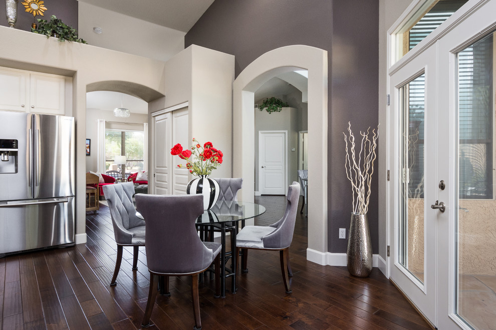 Kitchen/dining room combo - mid-sized transitional u-shaped dark wood floor kitchen/dining room combo idea in Phoenix with an undermount sink, raised-panel cabinets, white cabinets, granite countertops, gray backsplash, glass tile backsplash, stainless steel appliances and a peninsula