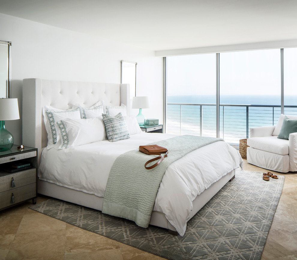 Design ideas for a mid-sized beach style master bedroom in San Francisco with white walls and brown floor.