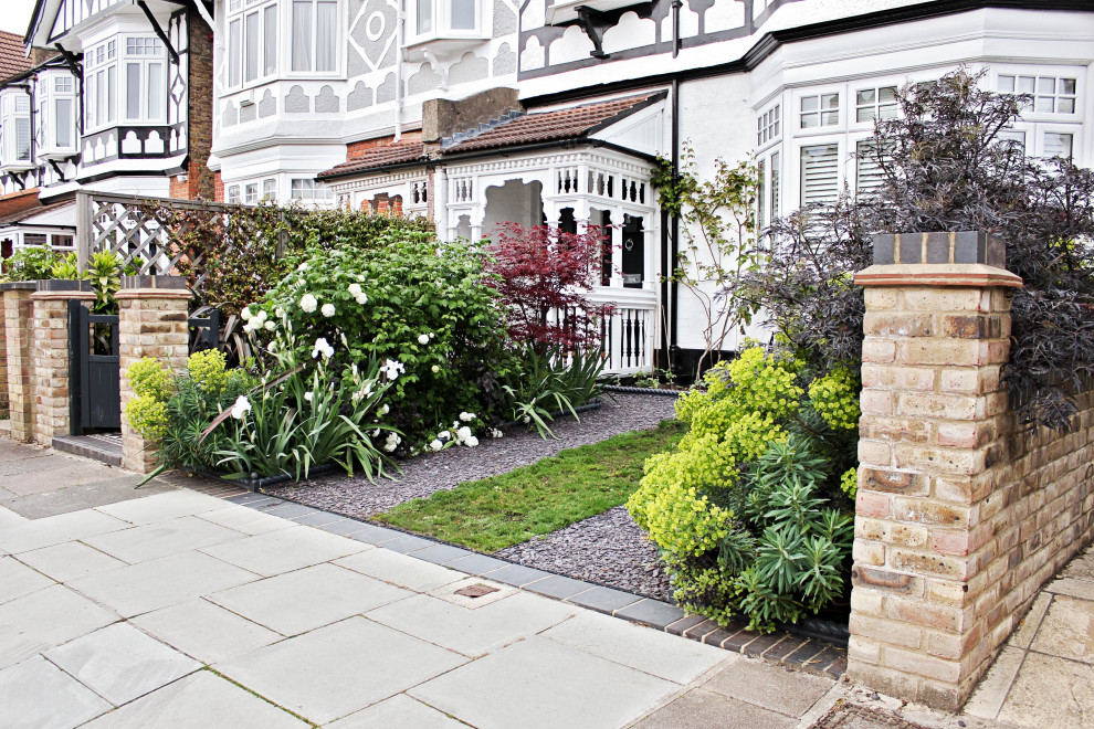 Photo of a medium sized farmhouse front driveway garden in London.