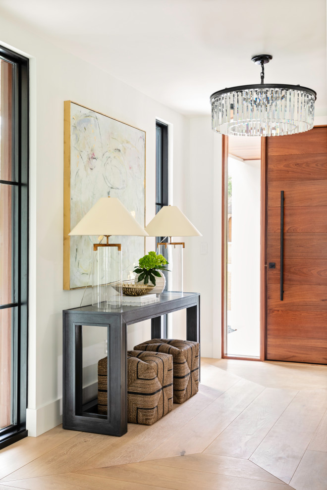 Inspiration for a mid-sized transitional foyer in Orlando with white walls, light hardwood floors, a single front door, a medium wood front door and beige floor.