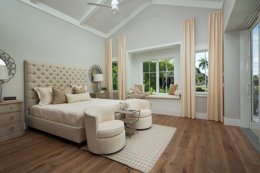 Beach style master bedroom in Miami with grey walls, light hardwood floors and no fireplace.