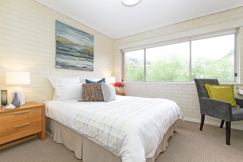 Design ideas for a contemporary bedroom in Hobart with beige walls and carpet.