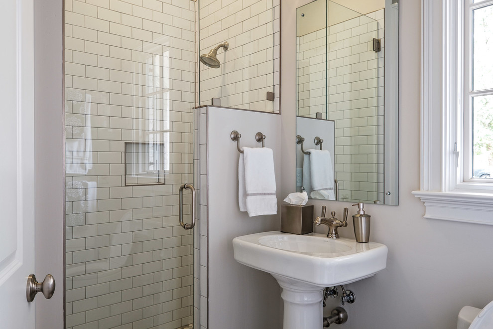 Photo of a mid-sized traditional 3/4 bathroom in Other with shaker cabinets, white cabinets, an alcove shower, a two-piece toilet, white tile, subway tile, white walls, porcelain floors, an undermount sink, quartzite benchtops, grey floor and a hinged shower door.