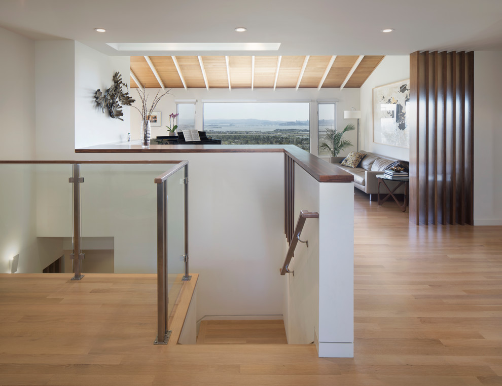 Inspiration for a mid-sized modern wood l-shaped staircase in San Francisco with wood risers and glass railing.