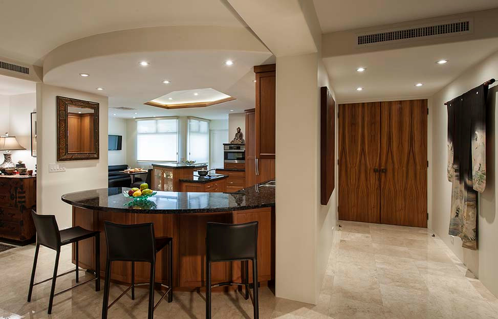 This is an example of a large traditional u-shaped eat-in kitchen in Hawaii with an undermount sink, recessed-panel cabinets, dark wood cabinets, granite benchtops, multi-coloured splashback, granite splashback, panelled appliances, travertine floors, with island, beige floor, multi-coloured benchtop and coffered.
