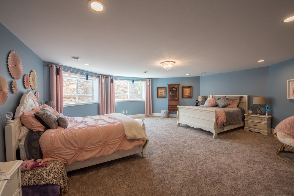 Photo of an expansive traditional kids' room for girls in Minneapolis with blue walls, carpet and brown floor.
