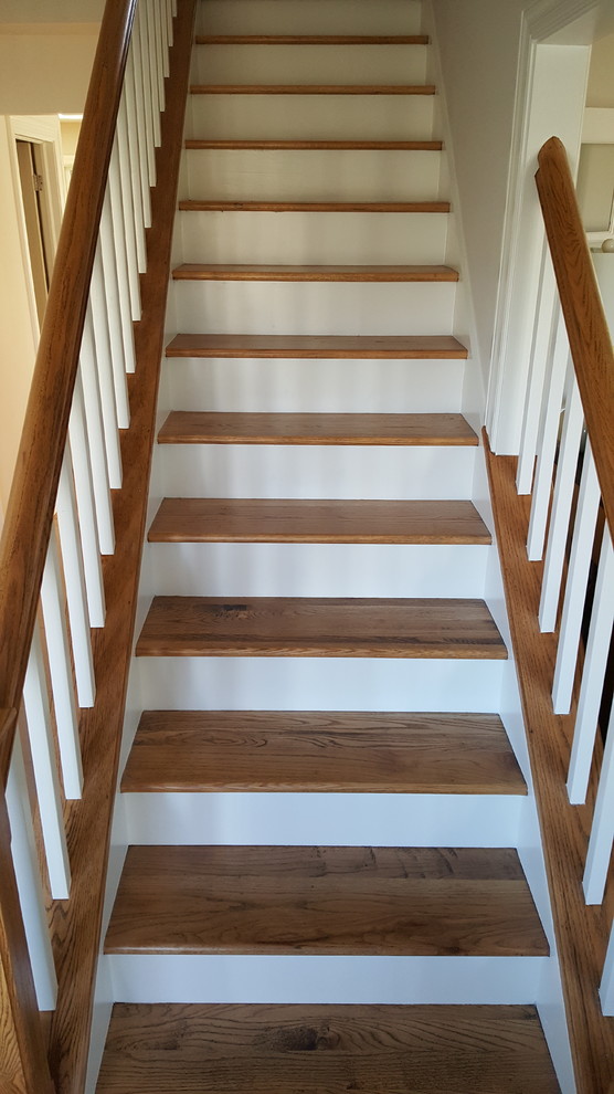 Example of a wooden straight staircase design in Chicago with painted risers