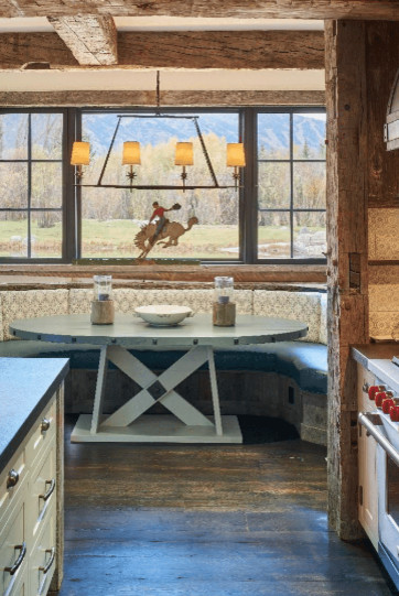 Inspiration for a mid-sized rustic u-shaped dark wood floor and brown floor eat-in kitchen remodel with a farmhouse sink, recessed-panel cabinets, white cabinets, quartz countertops, paneled appliances, an island and gray countertops