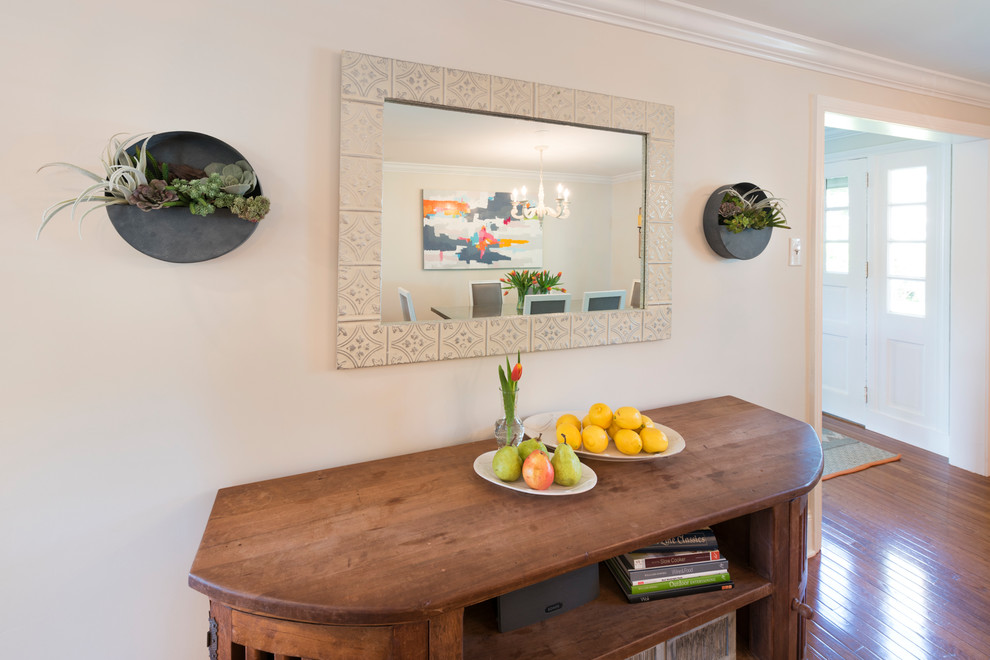 Inspiration for a mid-sized transitional l-shaped medium tone wood floor and brown floor enclosed kitchen remodel in Philadelphia with a farmhouse sink, raised-panel cabinets, beige cabinets, granite countertops, beige backsplash, mosaic tile backsplash, stainless steel appliances and an island