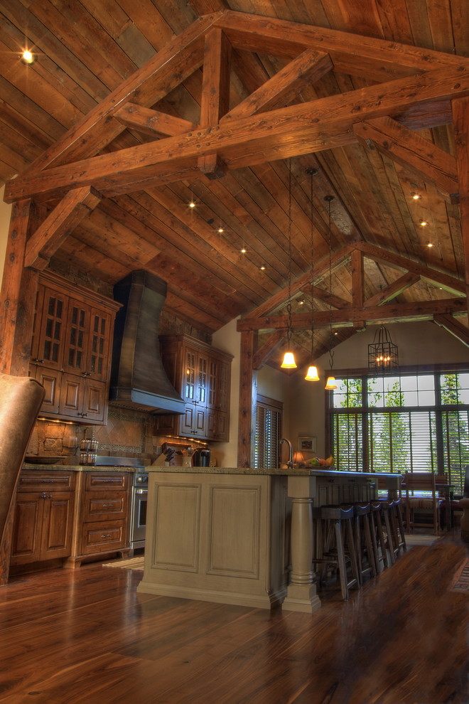 Inspiration for a country galley eat-in kitchen in Other with raised-panel cabinets and medium wood cabinets.