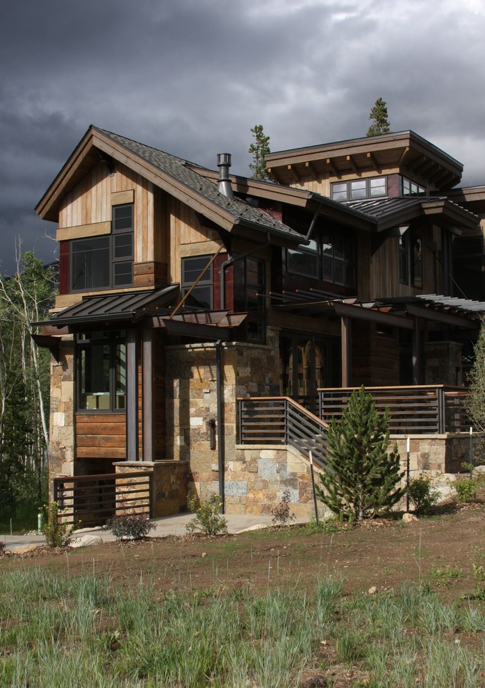 Inspiration for a mid-sized contemporary three-storey exterior in Denver with wood siding.