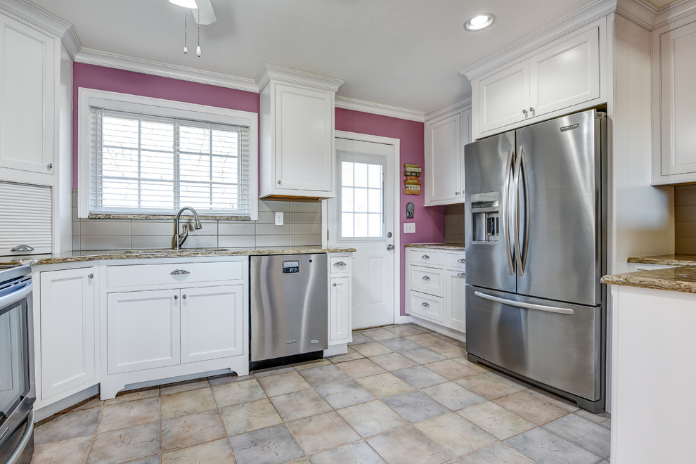 Inspiration for a mid-sized timeless u-shaped ceramic tile eat-in kitchen remodel with an undermount sink, recessed-panel cabinets, white cabinets, granite countertops, beige backsplash, ceramic backsplash, stainless steel appliances and no island