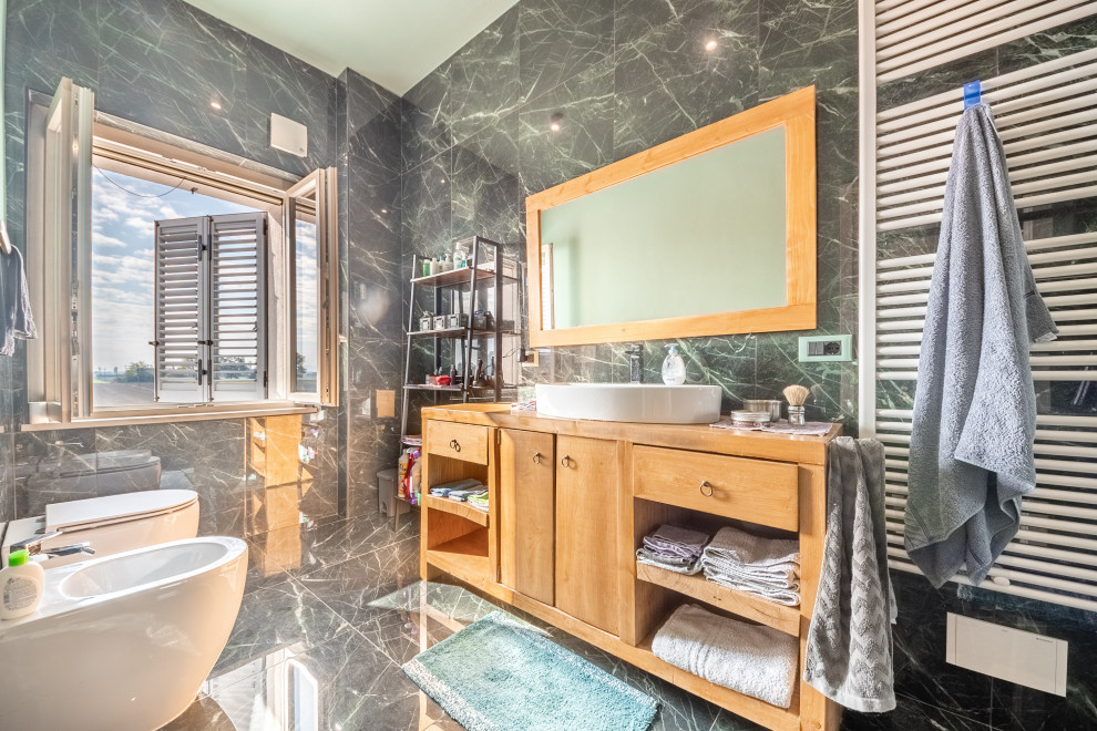 Photo of a large modern shower room bathroom in Milan with open cabinets, light wood cabinets, a built-in shower, a two-piece toilet, green tiles, porcelain tiles, porcelain flooring, a vessel sink, wooden worktops, green floors, brown worktops, a single sink, a floating vanity unit and a drop ceiling.