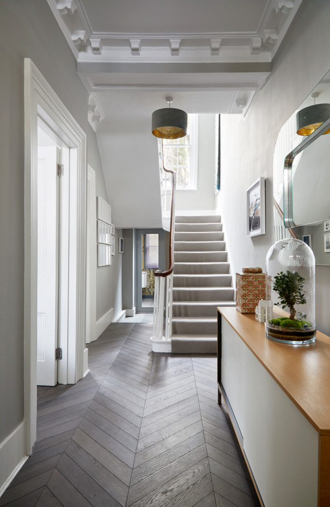 Inspiration for a large traditional hallway in London with grey walls, dark hardwood floors and grey floor.