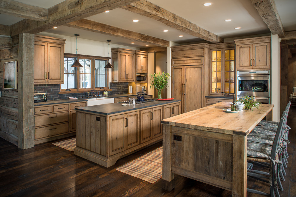 Inspiration for a country kitchen in Other with wood benchtops, dark hardwood floors, multiple islands, recessed-panel cabinets, medium wood cabinets and panelled appliances.