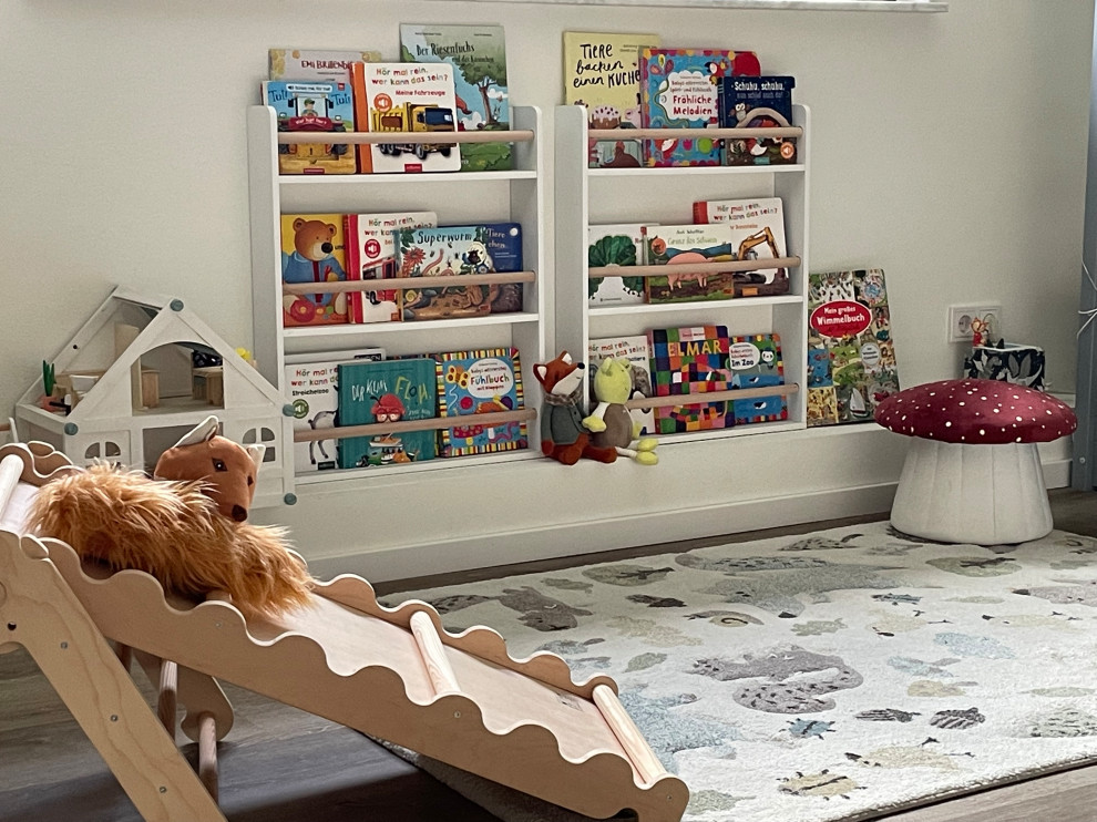 Large country gender neutral nursery in Cologne with beige walls, vinyl flooring, brown floors, a drop ceiling and wallpapered walls.