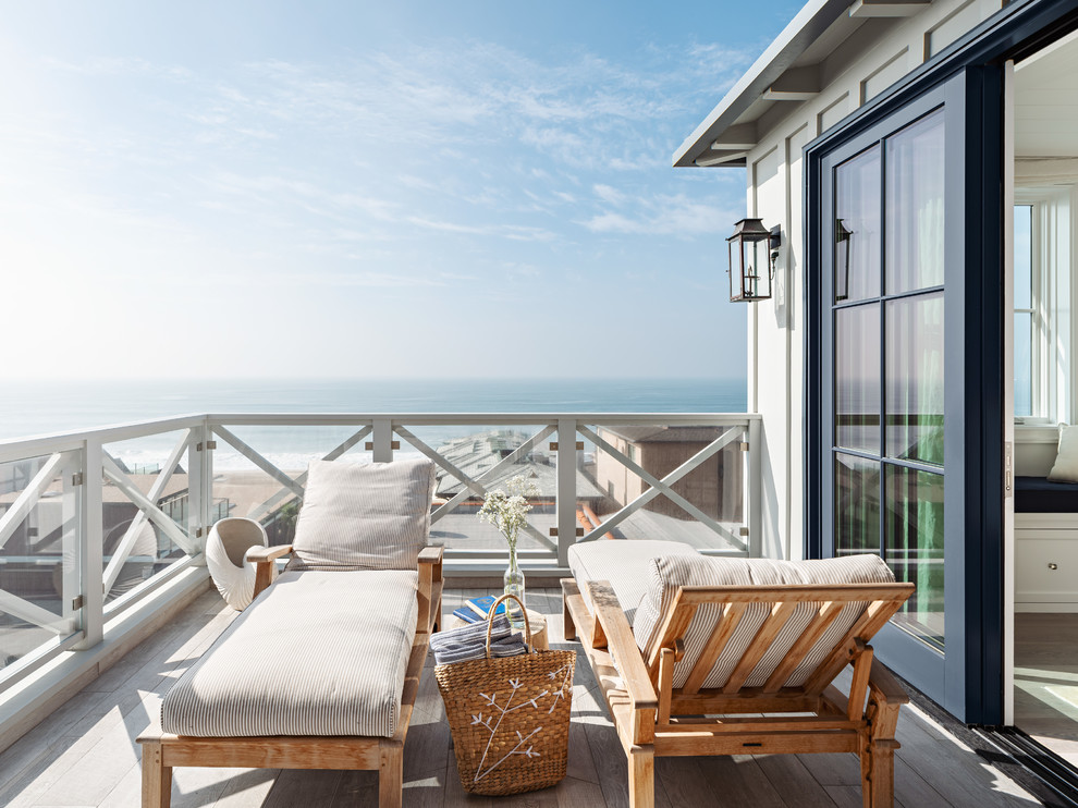 Photo of a beach style balcony in Los Angeles with no cover and mixed railing.