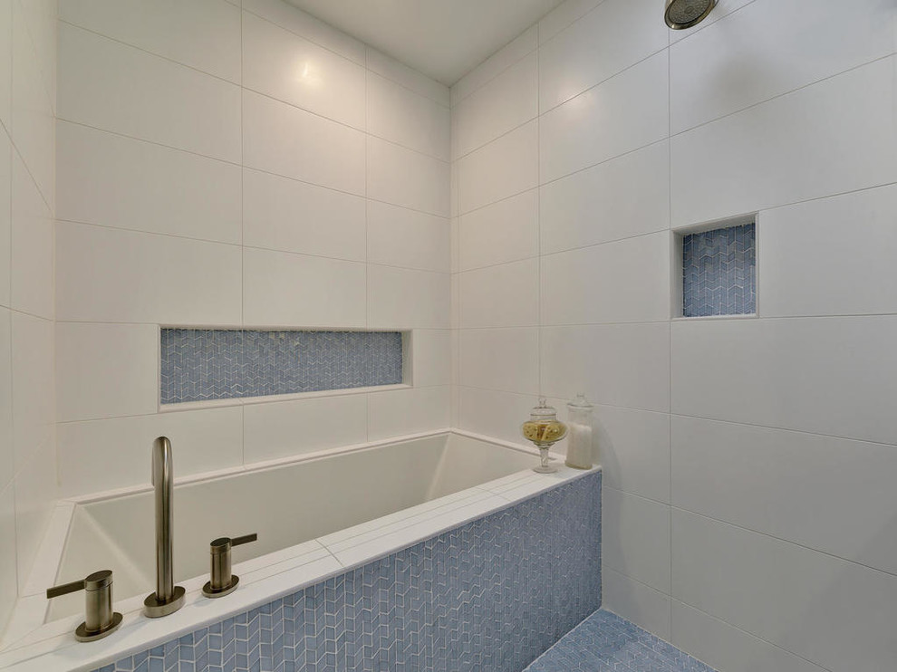 This is an example of a mid-sized modern master bathroom in Austin with an undermount tub, an open shower, blue tile, glass tile, white walls, concrete floors and an undermount sink.