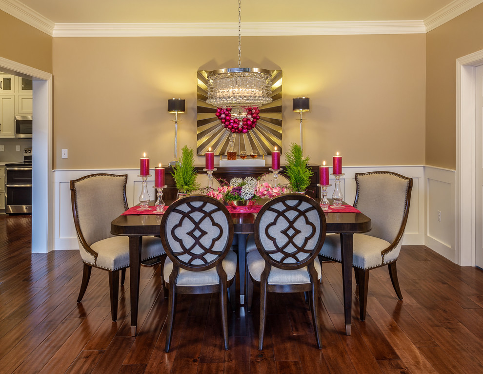 Small transitional medium tone wood floor dining room photo with brown walls