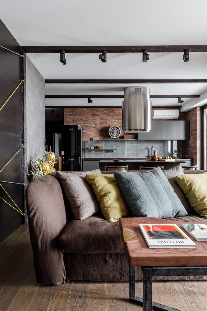 Mid-sized industrial loft-style living room in Other with a library, brown walls, porcelain floors, a ribbon fireplace, a brick fireplace surround, a wall-mounted tv and grey floor.
