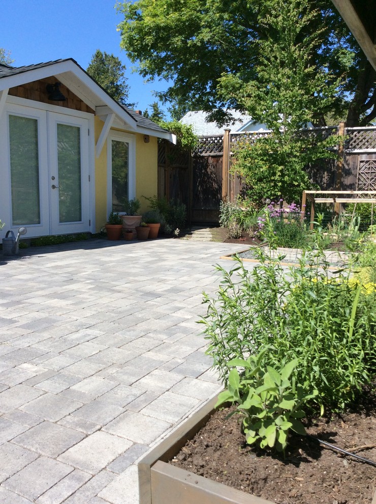 This is an example of a small mediterranean backyard patio in Other with a vegetable garden and concrete pavers.