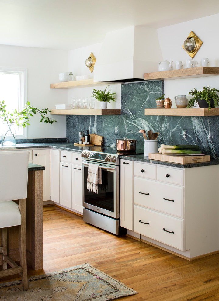 Design ideas for a large country l-shaped open plan kitchen in DC Metro with an undermount sink, shaker cabinets, light wood cabinets, soapstone benchtops, green splashback, stone slab splashback, stainless steel appliances, light hardwood floors, with island and green benchtop.
