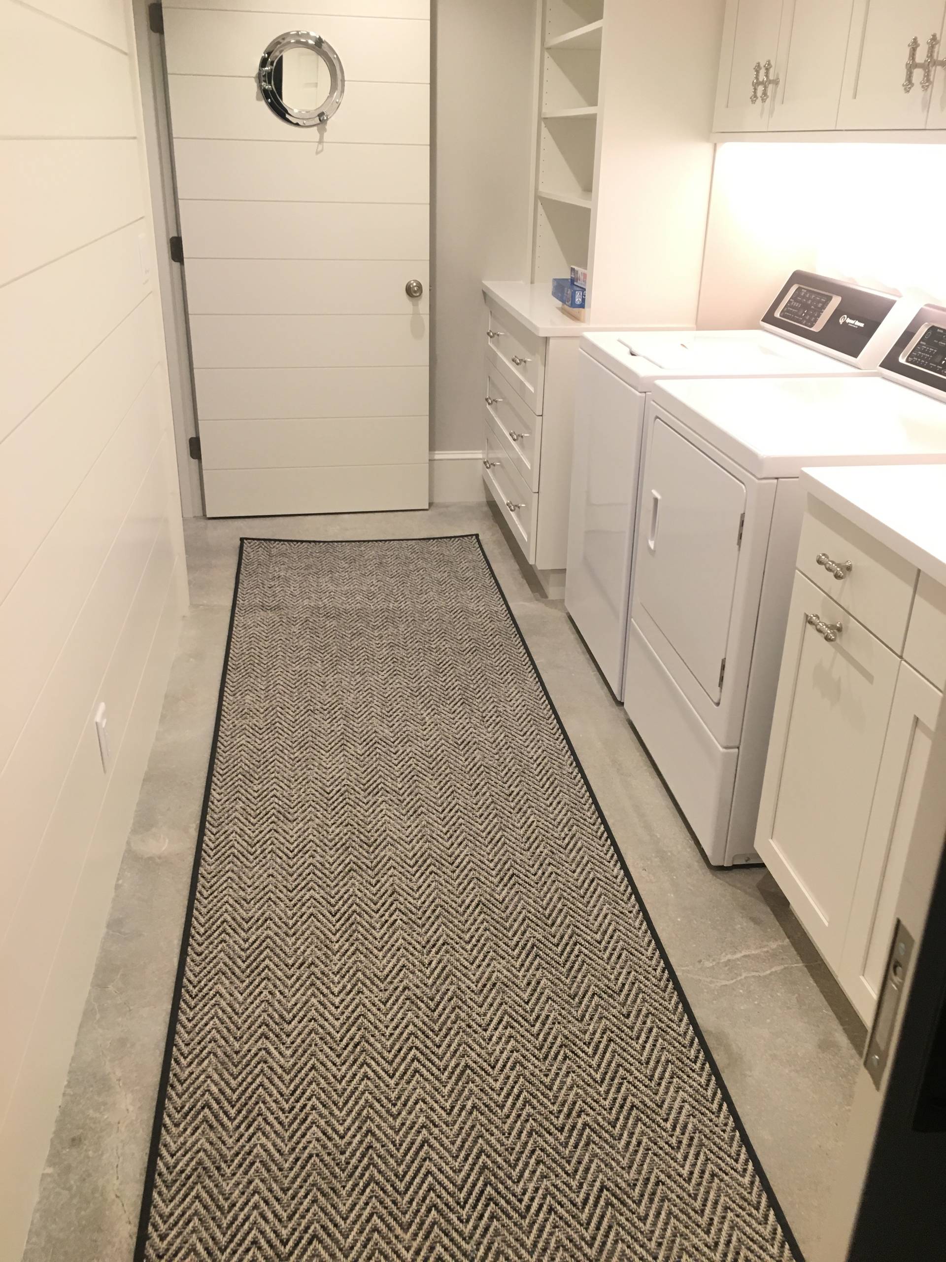 A fully equipped laundry room with a built ins