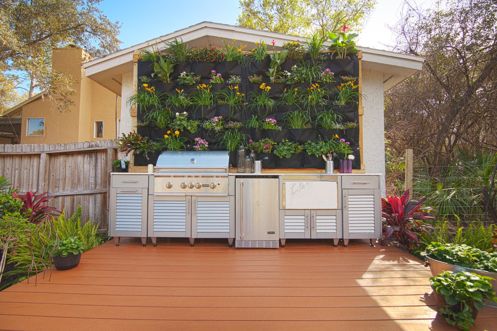 Photo of a backyard patio in Orlando with an outdoor kitchen, decking and no cover.