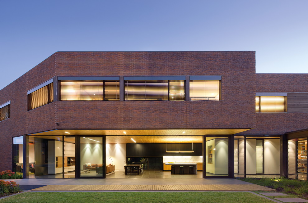 Photo of a large contemporary two-storey brick brown exterior in Melbourne.