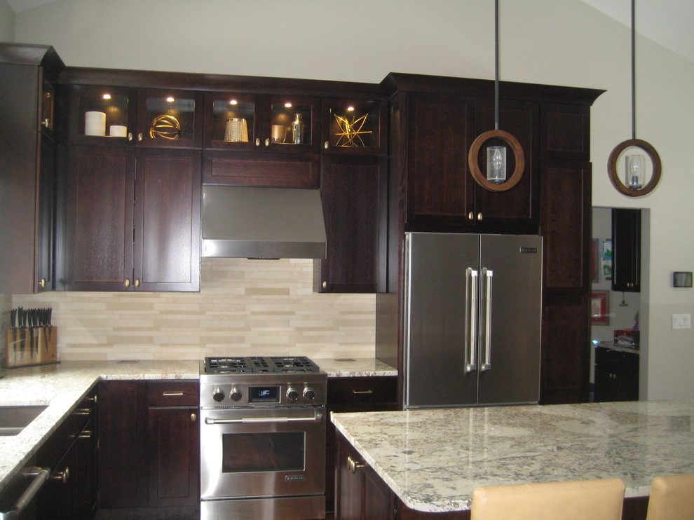 Mid-sized mountain style l-shaped dark wood floor open concept kitchen photo in Grand Rapids with a double-bowl sink, recessed-panel cabinets, dark wood cabinets, granite countertops, beige backsplash, matchstick tile backsplash, stainless steel appliances and an island
